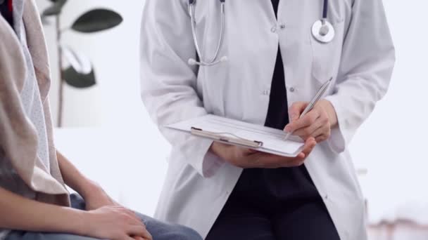 Doctor Kid Patient Clinic Closeup Unknown Female Physician Using Clipboard — Stock Video