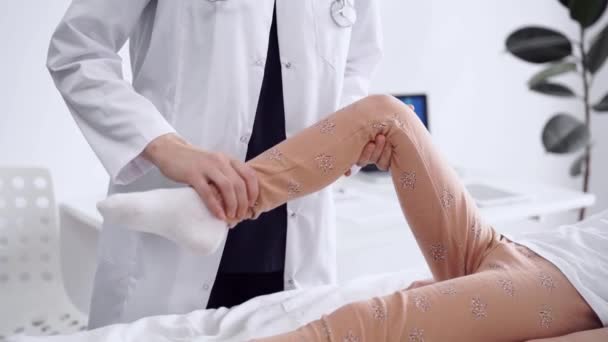 Dokter Patiënt Zijn Kliniek Orthopedisch Witte Jas Onderzoekt Kniegewricht Van — Stockvideo