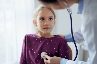 Çocuk hasta her zamanki sağlık kontrolünde. Evde doktor ve çocuk hasta var. Tıp, sağlık hizmetleri kavramları.