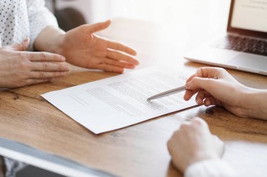 Business people discussing contract signing deal while sitting at the wooden table in office. Partners or lawyers working together at meeting. Teamwork, partnership, success concept. clipart