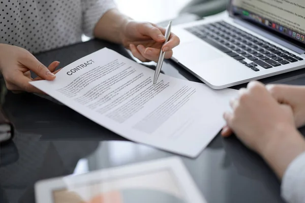 stock image Business people sitting and discussing contract in office, closeup. Partners or lawyers working together at meeting before signing papers. Teamwork and partnership.