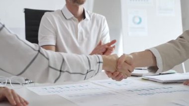 İki iş kadını başarılı bir toplantının ardından birbirleriyle tokalaşırlar, parlak, modern ofis ortamında bir iş anlaşmasını sağlamlaştırırlar. El sıkışma kavramı.