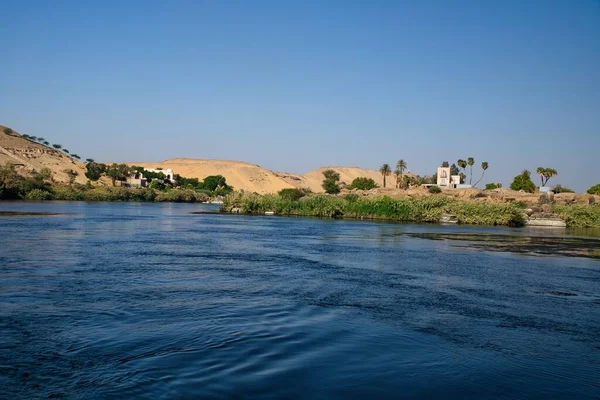 Panoramic view of landscape, flora and fauna around the world largest river Nile while cruising near Aswan in Egypt