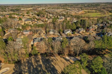 Aerial panoramic view of house cluster in a sub division in Suburbs in Georgia ,USA shot by drone shot during golden hour in winter of 2023.