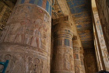 Ancient Egyptian structures, walls, columns, pillar covered colorful hieroglyphics of various shapes and ancient symbolism