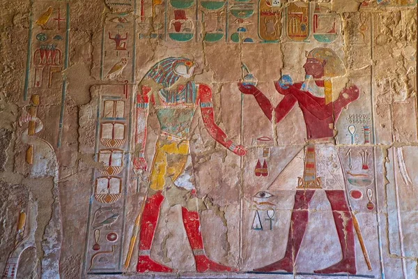 Ancient Egyptian structures, walls, columns, pillar covered colorful hieroglyphics of various shapes and ancient symbolism