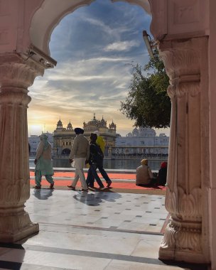 Amritsar, Punjab: December 14,2022- The panoramic view of the world famous Golden temple made of gold and ultimate holy place for Sikhs AMRITSAR, Punjab, India and devotes paying their respect to their Guru on a beautiful in December of 2022