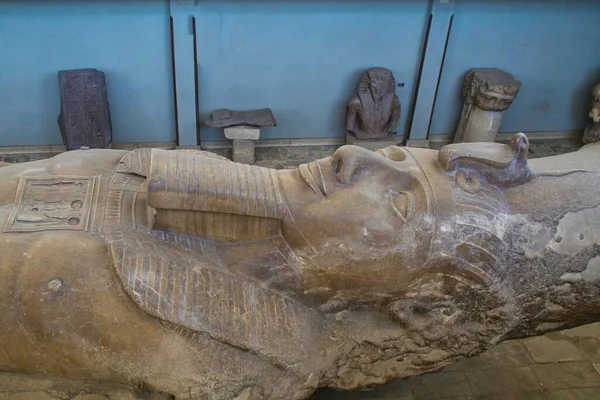 Lying down colossal statue of Ramsses II in Memphis museum in Egypt