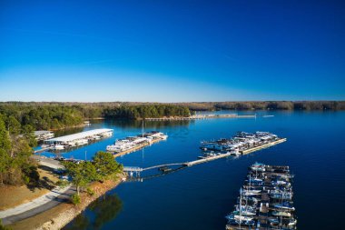 Aerial shot of the boats and yachts docked in the marina on the waters of Lake Lanier surrounded by lush green trees in Buford Georgia USA