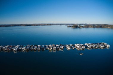 Aerial shot of the boats and yachts docked in the marina on the waters of Lake Lanier surrounded by lush green trees in Buford Georgia USA