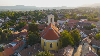 Drone view of Saint Peter and Paul Church in Szentendre Hungary showing the historic building and surrounding urban landscape