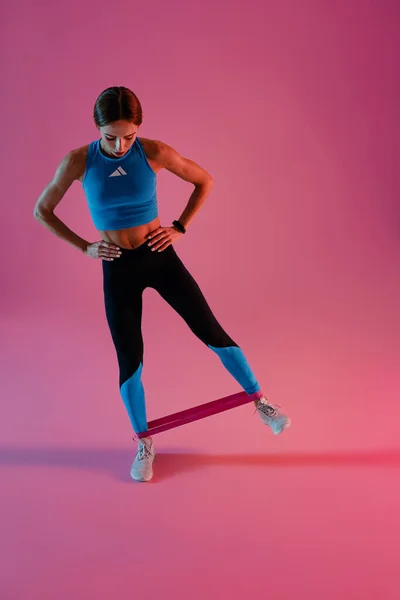 Athletic Woman Trains Legs Fitness Elastic Band Studio Background High — Stock Fotó