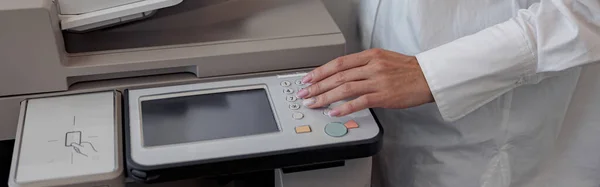 Close up of woman worker scanning document on photocopy machine In modern office. Blurred background