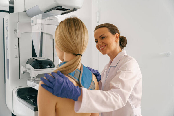 Woman doing mammogram x ray for breast cancer prevention screening at hospital