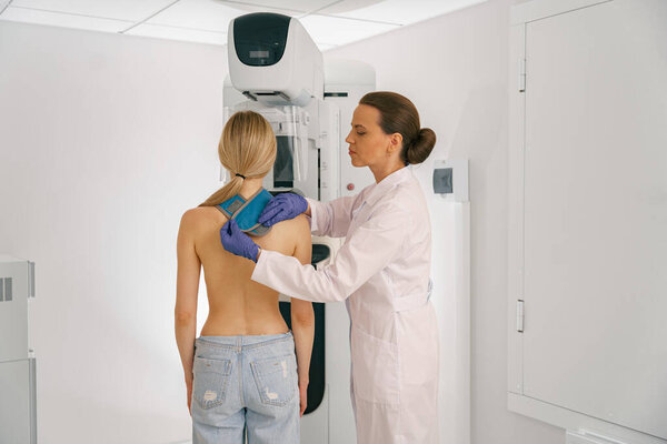 Woman doing mammogram x ray for breast cancer prevention screening at hospital