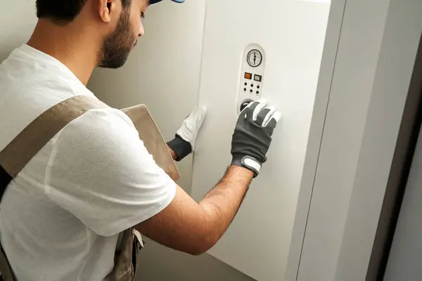 stock image Male worker in uniform is checking gas boiler . High quality photo