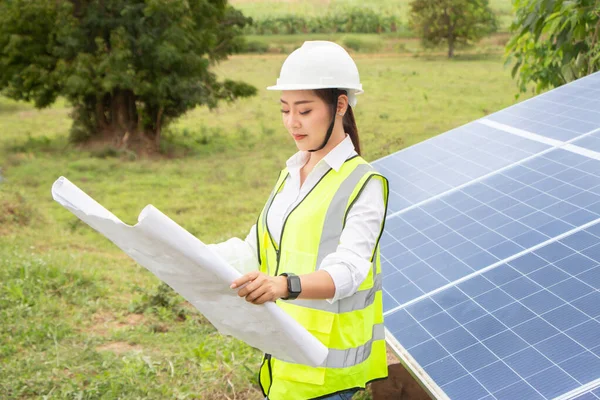 Female Manager Engineer Safety Helmet Checking With Tablet An Operation Of Solar Panel System At Solar Station