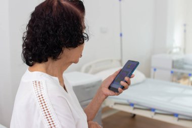 Doctor in charge of an elderly nursing home center is examining an elderly person in health care center.