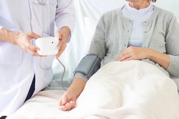 the doctor is examining the patient in the hospital.