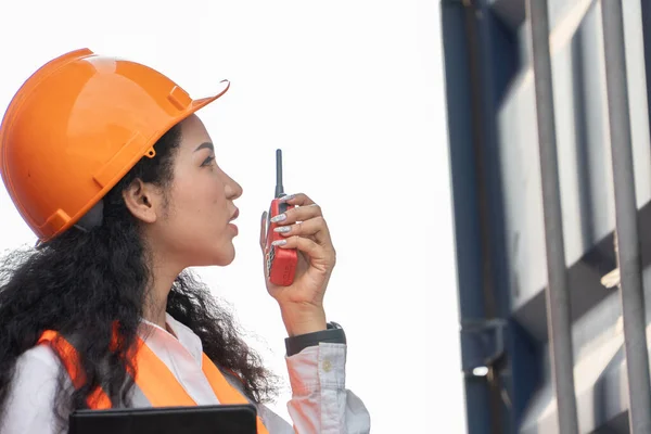 stock image Portrait of female worker In Cargo Containers In Shipping Container Yard. woman holding walkie-talkie and digital tablet.