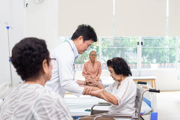 Nursing Home Care concept. A group of elderly people in nursing homes meeting with nursing care assistants