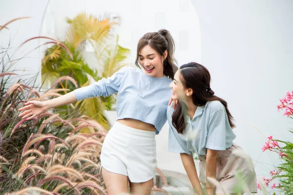happy asian woman and friend in garden