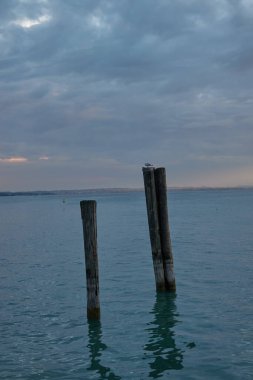 Lazise, Italy - September 25, 2022 - twilight over Lago di Garda in early autumn                               