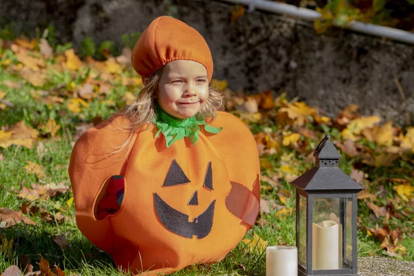 Little Girl Pumpkin Costume Sitting Grass Glass Lantern Candle Halloween — Stock Photo, Image