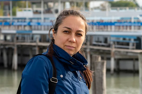 stock image A beautiful 40-year-old woman in a jacket on the background of a marina