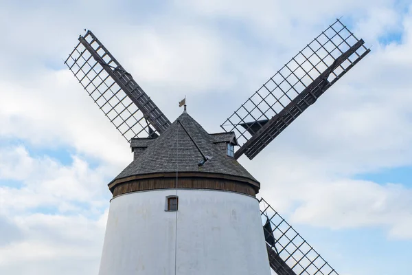 Stock image Windmill on the background of a blue sky with clouds.