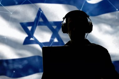 Silhouette of a military man in headphones at a laptop against the background of the flag of Israel, contour lighting. Concept: collection of confidential information, Jewish special services. clipart