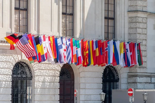 Many flags of different countries on the facade of the building, an international organization