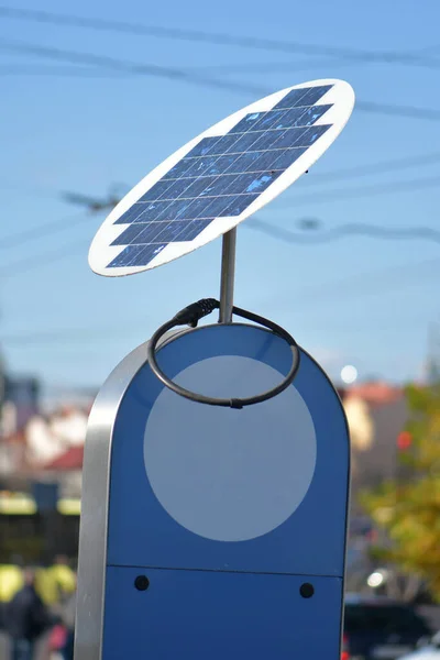 compact solar battery against the backdrop of city houses