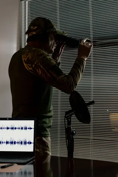 İstihbarat memuru kapalı bir odadan gözetleme yapıyor. Gözetim anlayışı, özel operasyonlar, keşif