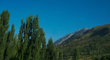                                Yüksek dağlar ve mavi gökyüzü görünür
