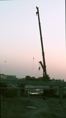 Gün batımında uzun bir vinç uzaktan görülebilir..