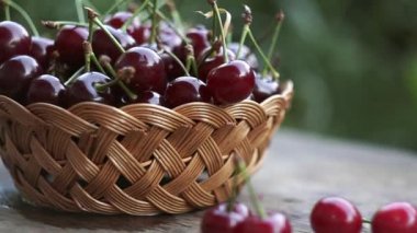 Kirazlar dışarıda bir sepette duruyor.