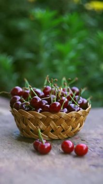 Kirazlar dışarıda bir sepette duruyor.