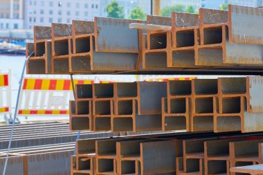 Arkaplan olarak inşaat alanındaki paslı çelik yığınları