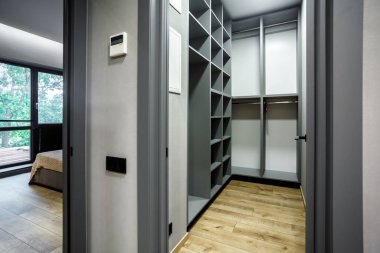 Modern scandinavian loft wood walk in closet with wardrobe