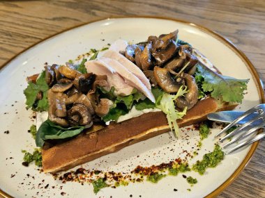 Tavuk filetosu, mantar ve roka ile Belçika waffle 'ı. Belçika yemeği. Yukarıdan görüntüle.