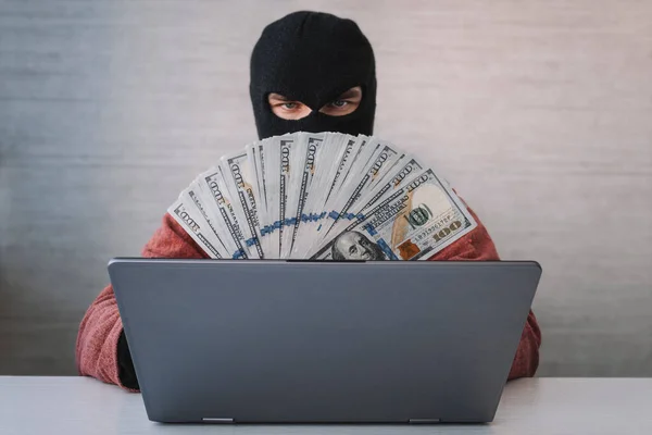 Male Thief Holds Dollars His Hand Using Laptop Computer Password — Stock Photo, Image
