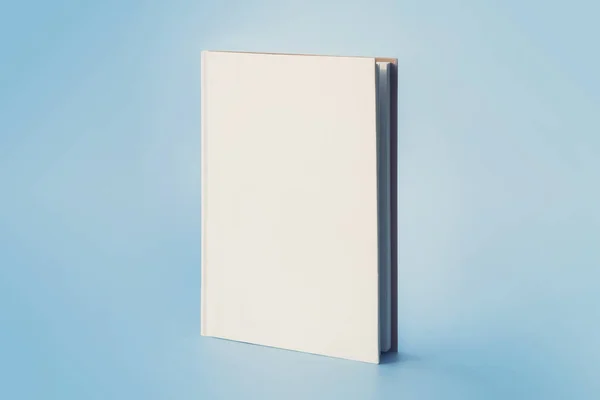 a white book on a blue background. Empty space on the cover for design and text