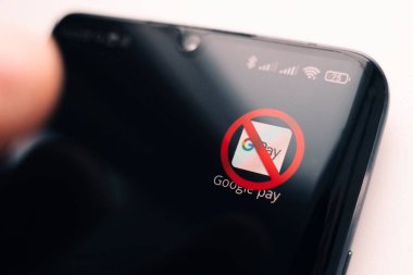 A crossed-out icon on a black smartphone screen. the concept of banning the application google pay. April 1, 2022. Barnaul. Russia