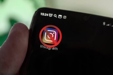 A crossed-out icon on a black smartphone screen. the concept of banning the application instagram. April 1, 2022. Barnaul. Russia
