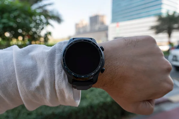 Sports, athlete or runner with smart watch in an urban street. Fitness, city and smartwatch of a man hands training, workout or exercise with technology update, results check and time progress report.