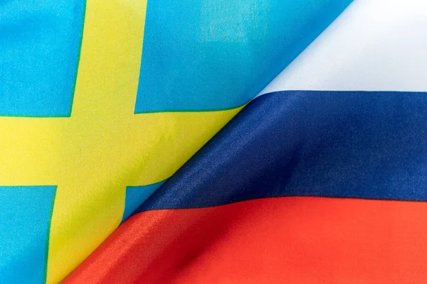 Flags of the sweden and Russia. The concept of international relations between countries. Sanctions against Russia. The state of governments. Friendship of peoples.