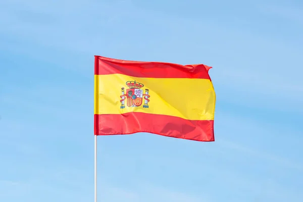 Spain flag on the bluec loudy sky with clipping path. close up waving flag of Spain. flag symbols of Spain.