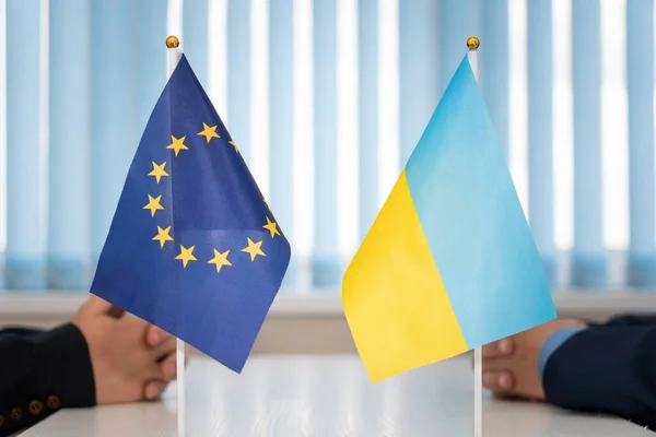 Political flags of Ukraine and European Union.. concept of negotiations, collaboration and cooperation of countries. agreement between the governments. Ukraine's accession to the European Union.