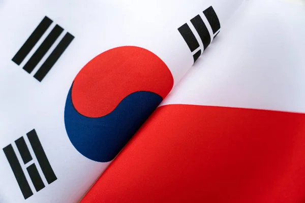 Flags south korea and Poland. The concept of international relations between countries. The state of governments. Friendship of peoples.